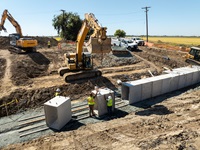 California Department of Water Resources Utility Craftsworkers, from the Sutter Maintenance Yard Division of Flood Operations, work to repair a culvert at the intersection of Schlag Road and Bogue Road in Yuba City in Sutter County. The new culverts will allow more water to flow that will end up in the Sutter Bypass. Photo taken September 22, 2025.