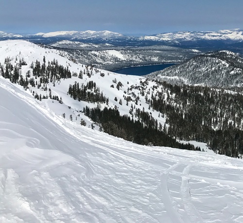 View of snow covered Sierra Nevada mountains in Nevada County, California.